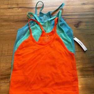 Three athletic women’s tank tops